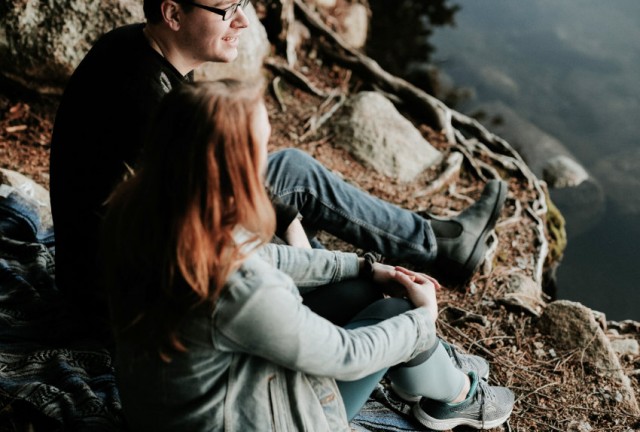 two-young-people-sitting-by-country-river