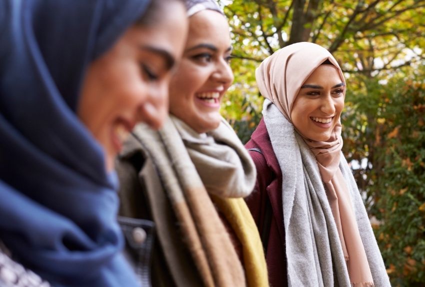 group of women wearing headscarves and smiling