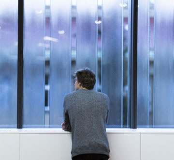Man looking out window