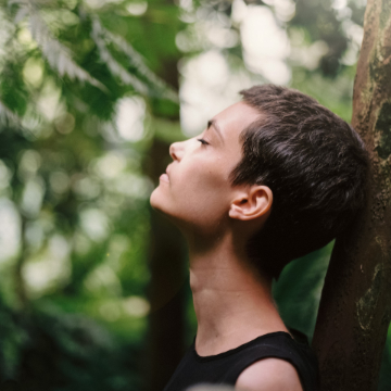 Woman meditating in a forest