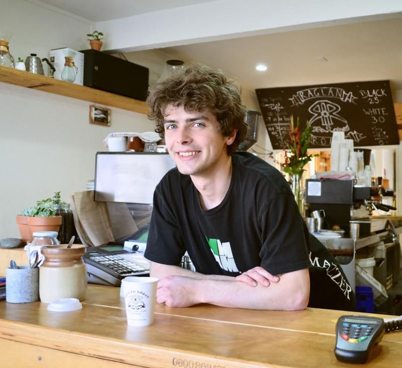 Young man working in a cafe